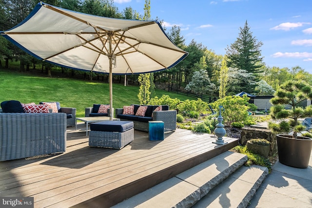 wooden deck featuring an outdoor living space and a yard