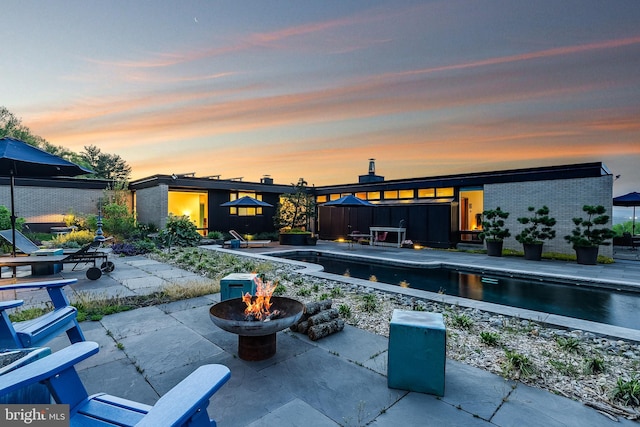 patio terrace at dusk with a fire pit