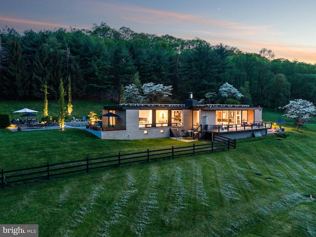 back house at dusk with a yard