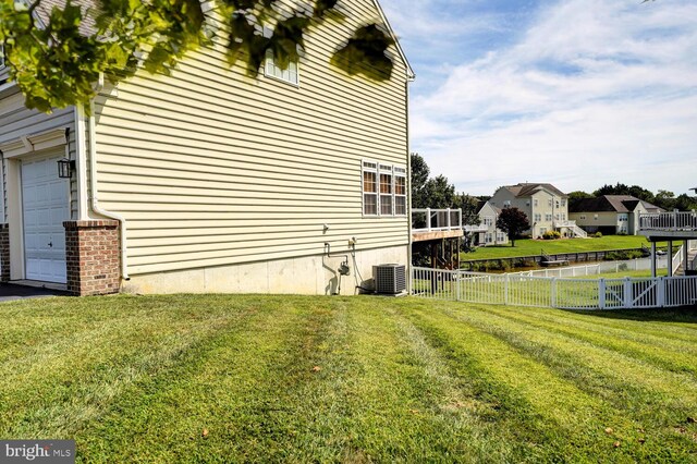 view of home's exterior featuring a yard, fence, and a garage