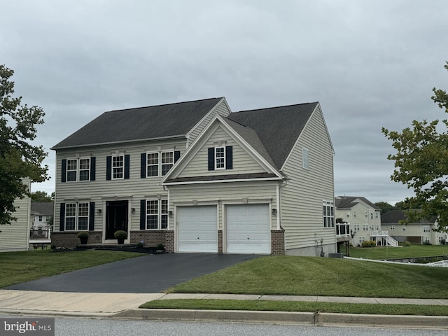 view of front of property with a garage and a front lawn