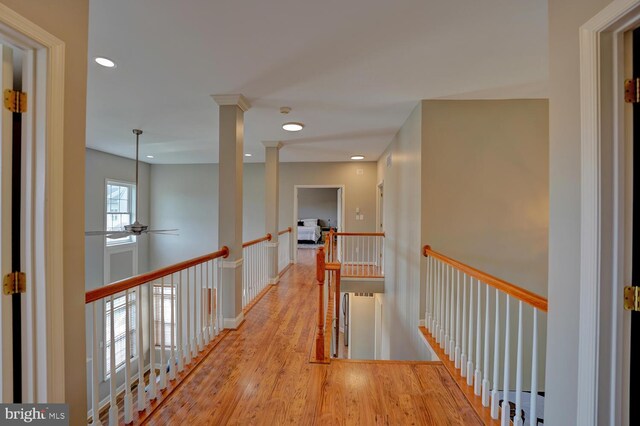 corridor featuring recessed lighting, wood finished floors, and an upstairs landing