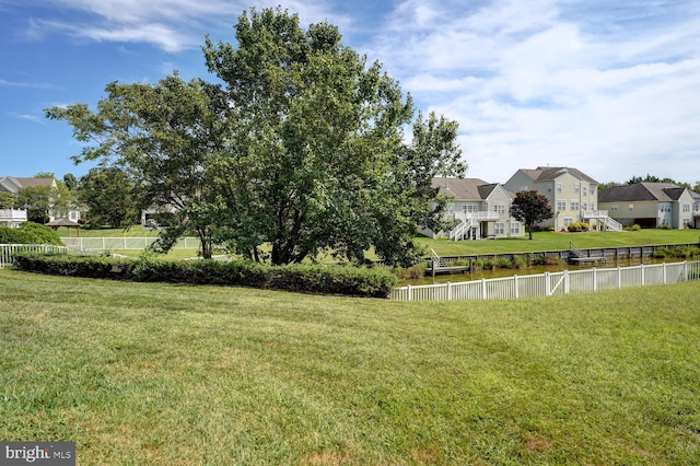 view of yard with fence and a residential view