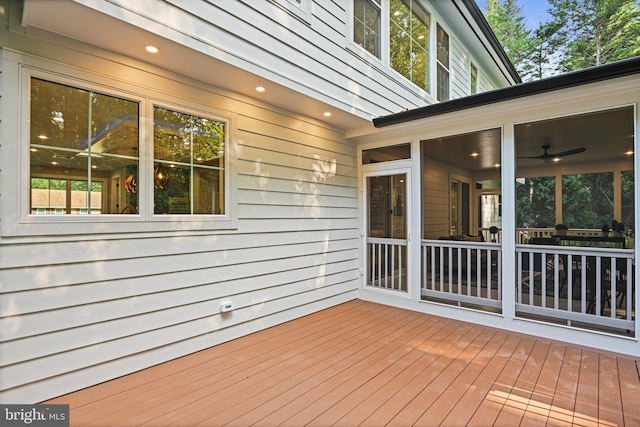 wooden deck featuring a sunroom