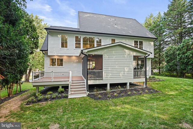 back of house featuring a yard and a wooden deck