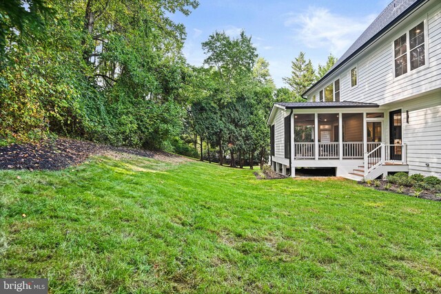 view of yard featuring a sunroom