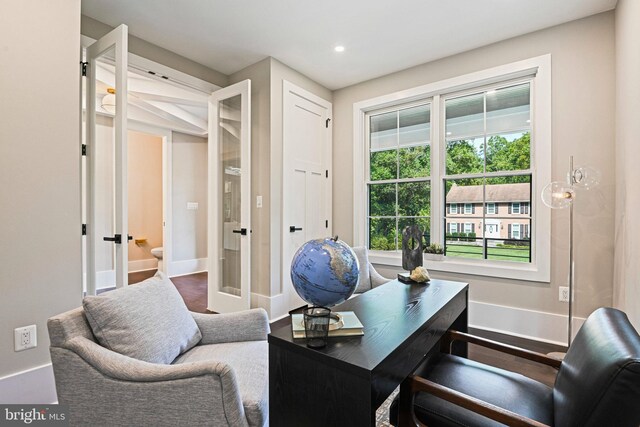 living room featuring dark wood-type flooring, a high end fireplace, and a raised ceiling