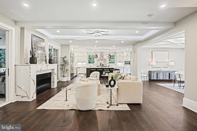 living room featuring recessed lighting, a fireplace, dark wood finished floors, and baseboards