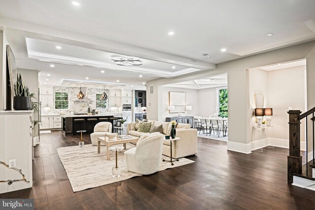 sitting room featuring dark hardwood / wood-style flooring and a healthy amount of sunlight