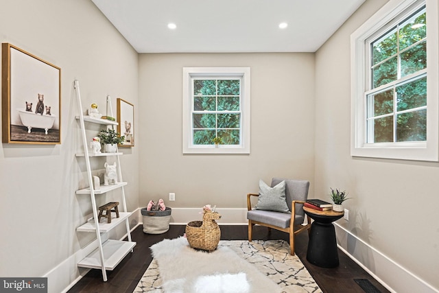 sitting room with a wealth of natural light, dark wood-type flooring, and recessed lighting