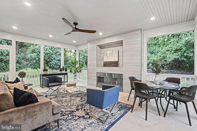 exterior space with wood ceiling, ceiling fan, and a premium fireplace