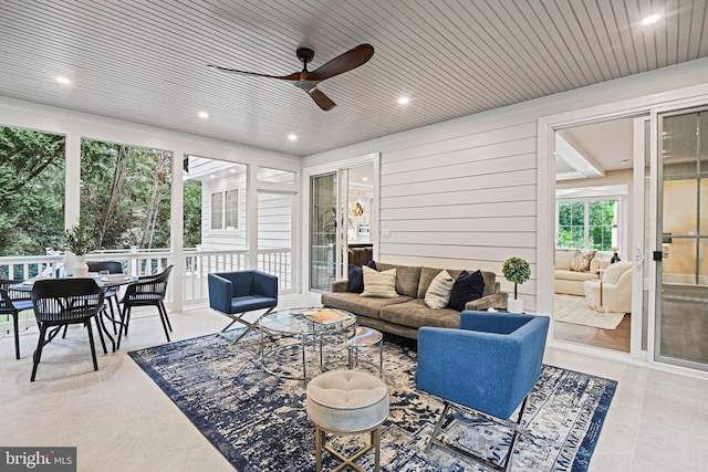 sunroom with wooden ceiling and ceiling fan