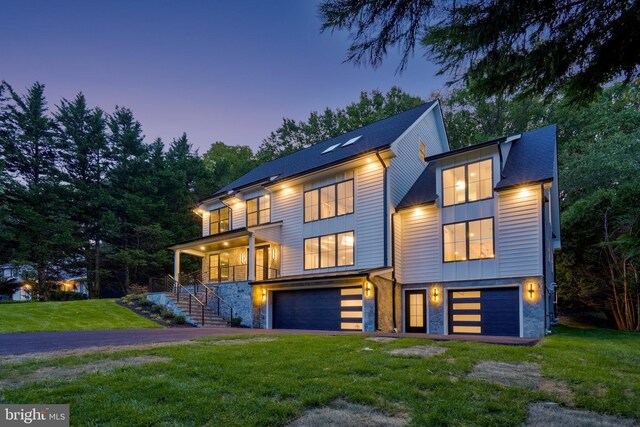 view of front of property with a lawn and a garage