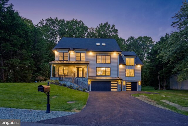 view of front of house with a garage and a front yard