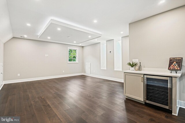 bar with dark wood-type flooring and wine cooler