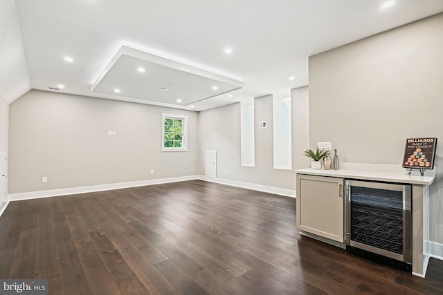 interior space with baseboards, dark wood-style floors, wine cooler, a bar, and recessed lighting