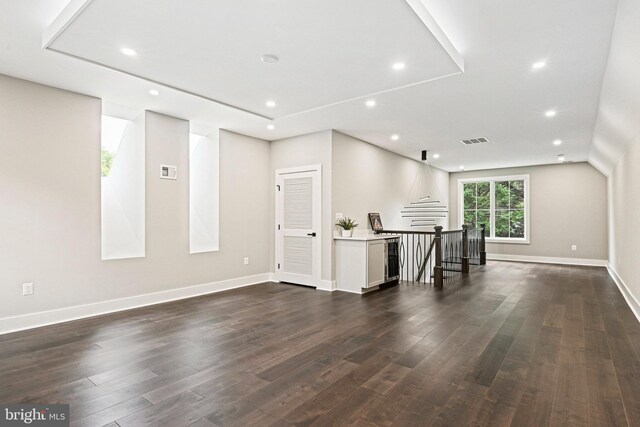 unfurnished living room with dark hardwood / wood-style floors