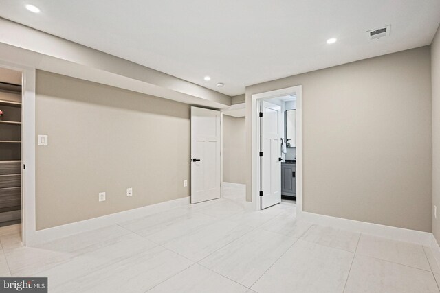 basement with light tile patterned flooring