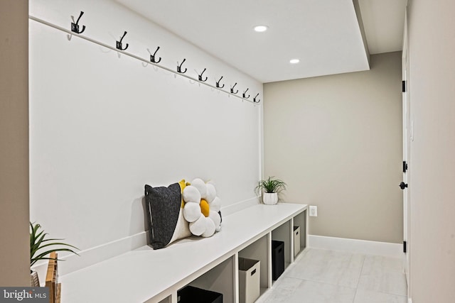 mudroom with light tile patterned floors, baseboards, and recessed lighting