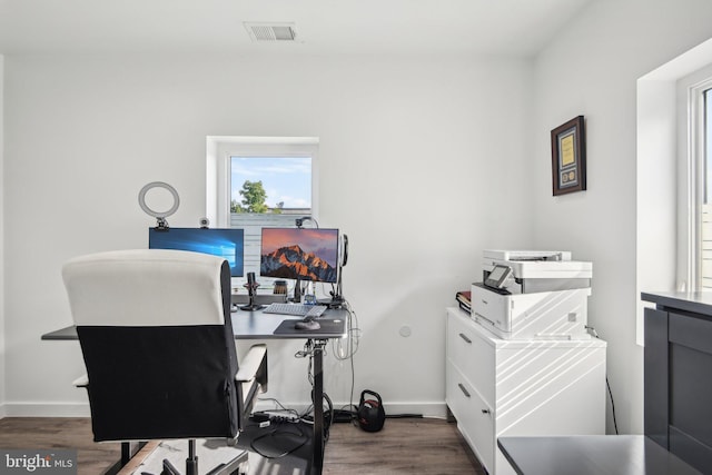 office featuring baseboards, visible vents, and wood finished floors