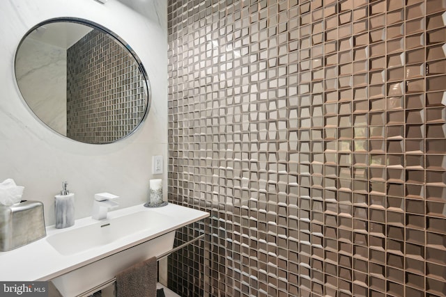 bathroom with tile walls and sink