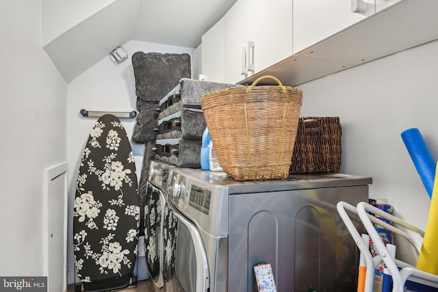 laundry area featuring cabinets and washing machine and dryer