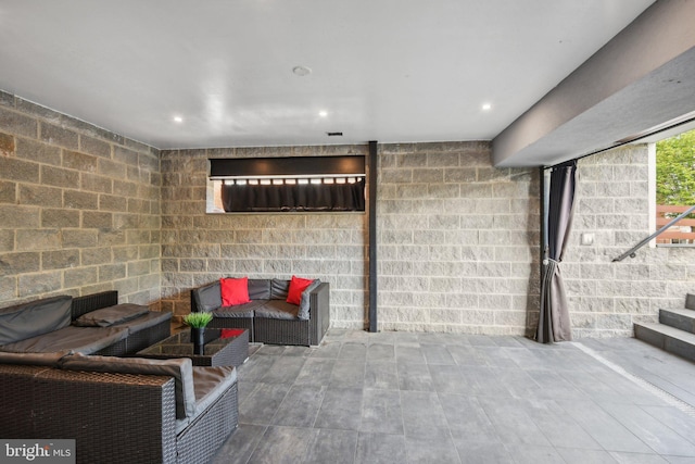 basement featuring stairway and recessed lighting