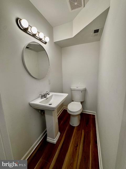 bathroom with toilet and hardwood / wood-style flooring