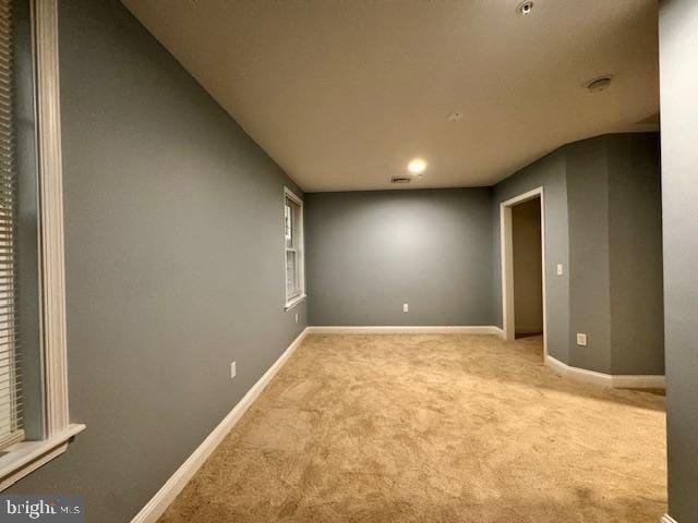 unfurnished room with light colored carpet