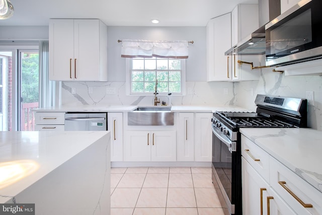 kitchen with stainless steel appliances, backsplash, wall chimney exhaust hood, and white cabinets