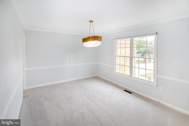 carpeted empty room featuring an inviting chandelier, baseboards, visible vents, and ornamental molding