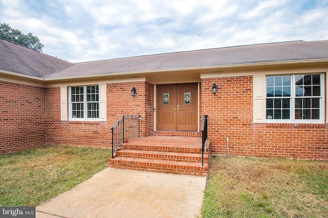 property entrance with brick siding