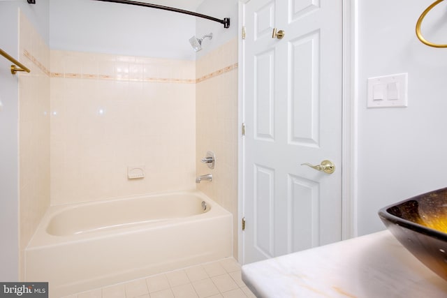 bathroom with tile patterned floors and shower / washtub combination