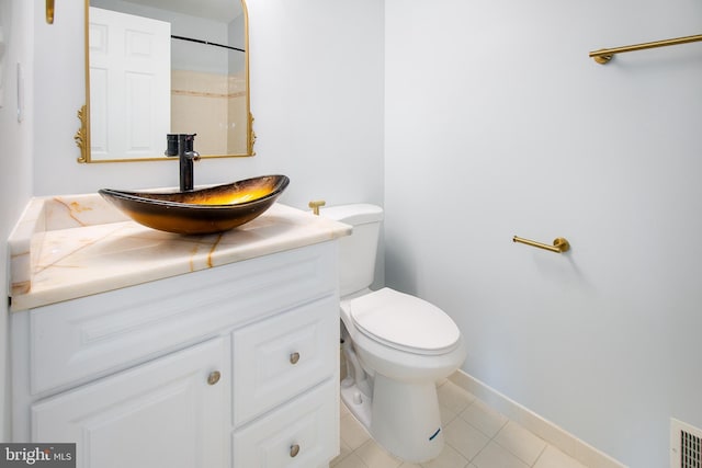 bathroom with visible vents, baseboards, toilet, tile patterned floors, and vanity