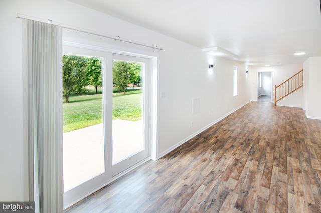 interior space featuring stairway, baseboards, and wood finished floors