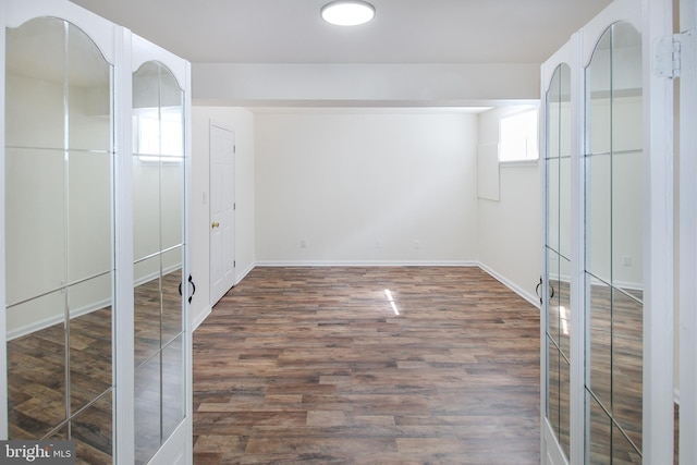 unfurnished bedroom featuring wood finished floors and baseboards