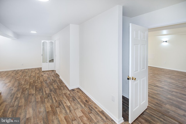 hallway with wood finished floors and baseboards