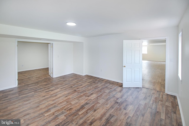 spare room with wood finished floors and baseboards