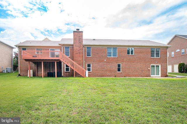 rear view of property featuring a yard, central AC unit, brick siding, and a chimney