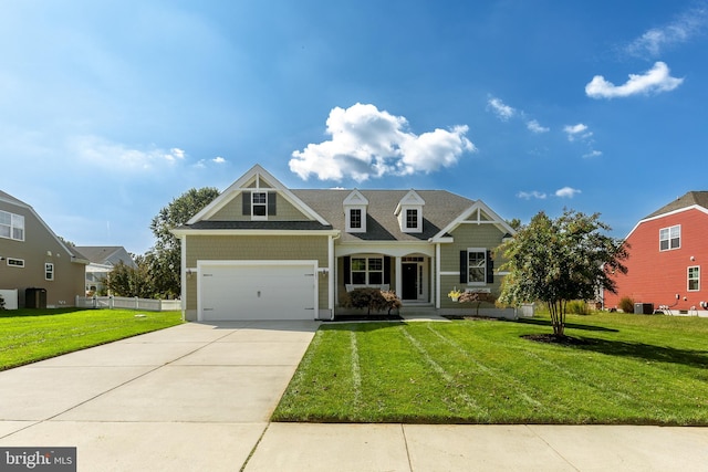 view of front of property with a front lawn and a garage