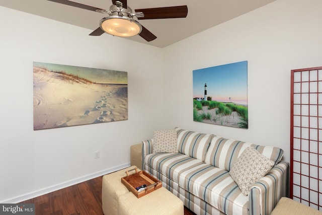 living room featuring dark wood-type flooring and ceiling fan