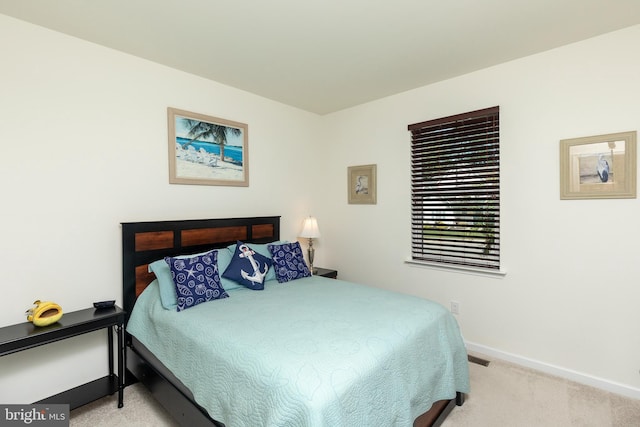 bedroom featuring light carpet