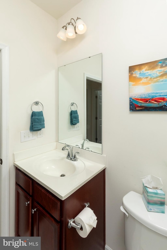 bathroom featuring toilet and vanity