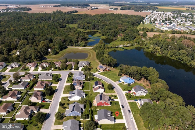 bird's eye view featuring a forest view, a water view, and a residential view