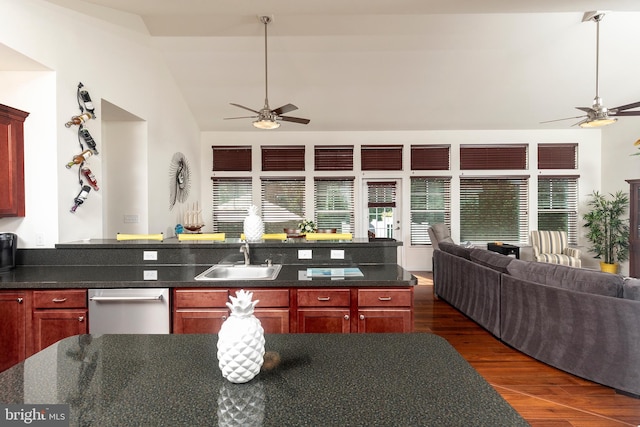 kitchen featuring dishwasher, sink, lofted ceiling, dark wood-type flooring, and ceiling fan