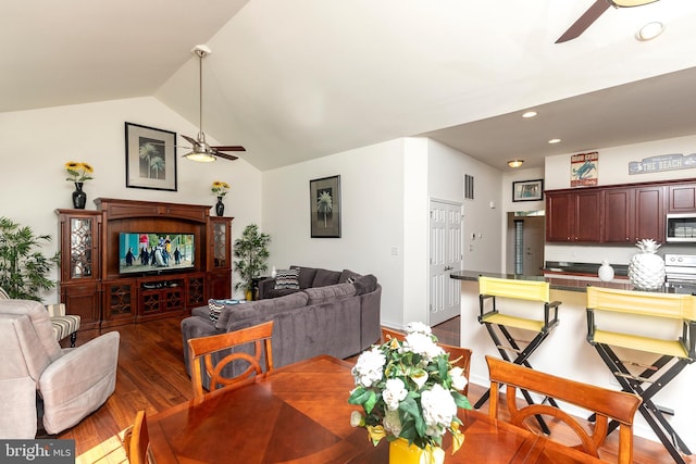 dining area featuring lofted ceiling, dark wood-type flooring, and ceiling fan