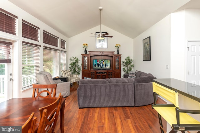 living room with dark hardwood / wood-style flooring, ceiling fan, and lofted ceiling