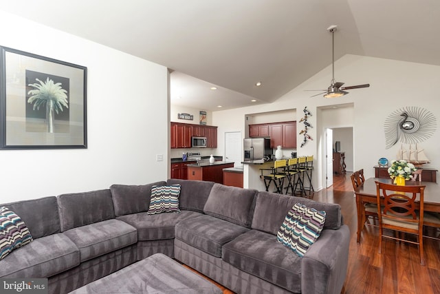 living room with lofted ceiling, ceiling fan, and dark hardwood / wood-style floors