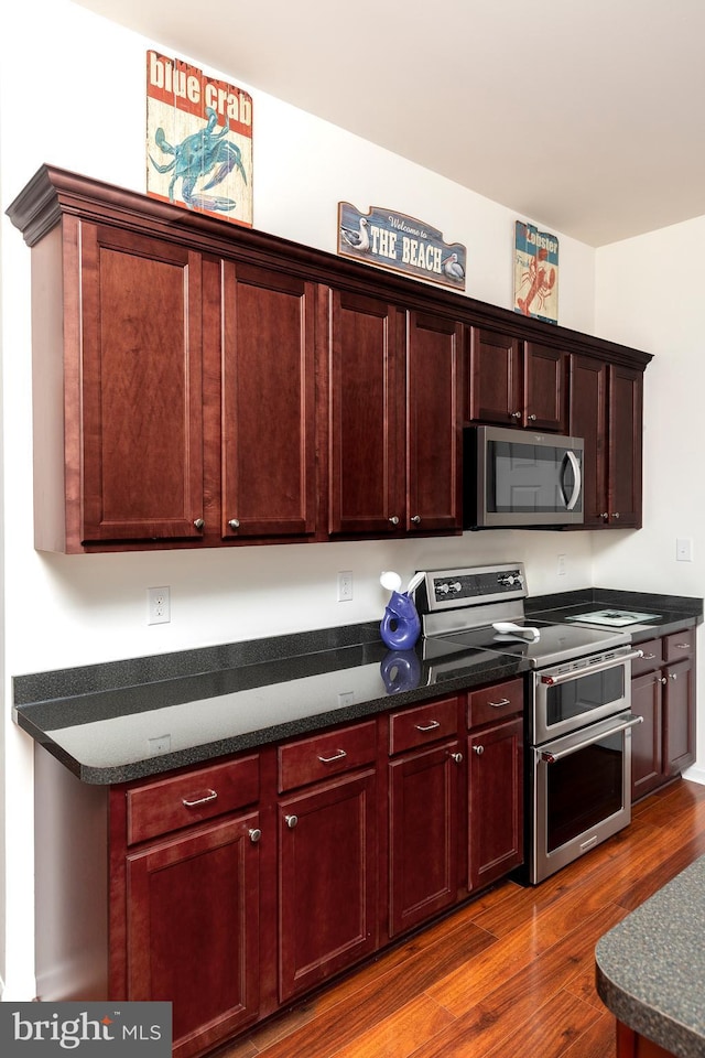 kitchen with appliances with stainless steel finishes and wood-type flooring