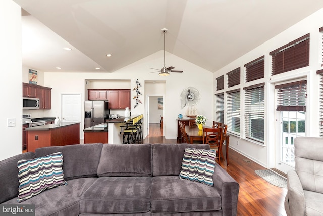 living room featuring lofted ceiling, ceiling fan, and dark hardwood / wood-style floors